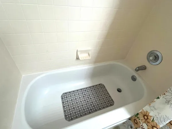 a bathroom with a bathtub and shower