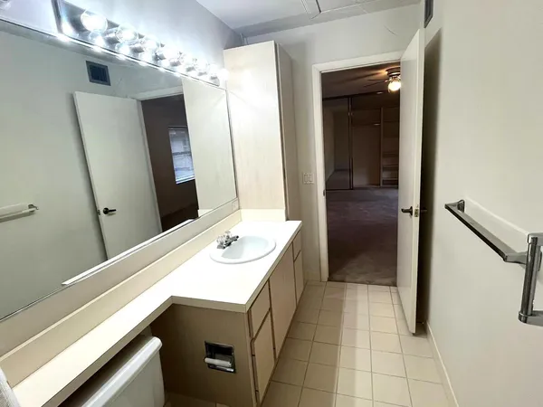 a en suite bathroom with a sink double vanity and a mirror