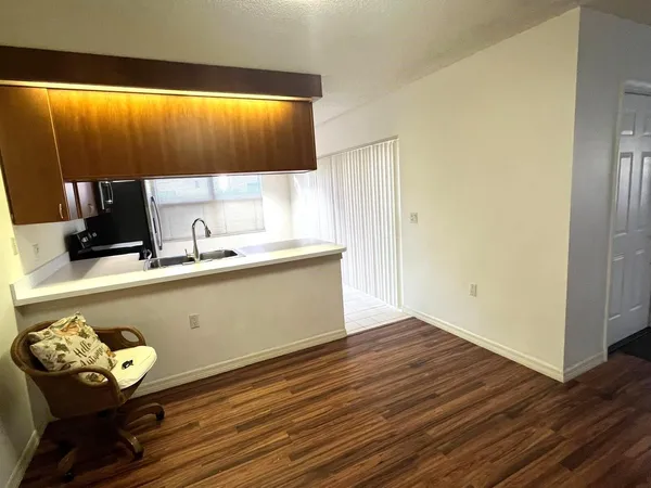 a kitchen with a wooden floor and a sink