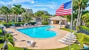a view of a house with swimming pool and sitting area