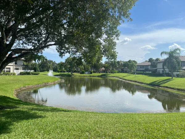 a view of a lake with a house in the background