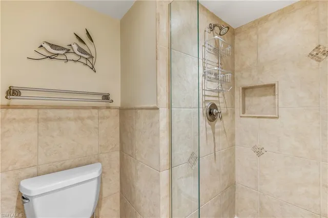 a bathroom with a shower and toilet