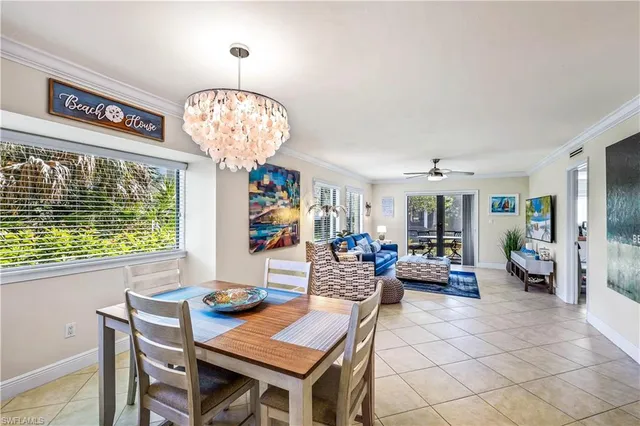 a view of a dining room with furniture large windows and wooden floor