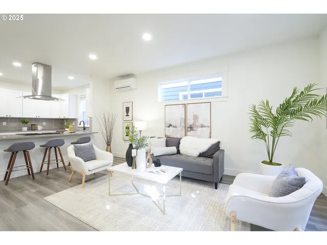 a living room with furniture and a potted plant