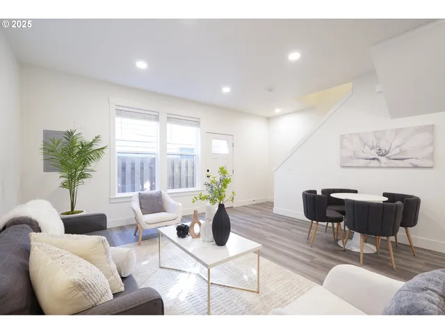 a living room with furniture and a potted plant