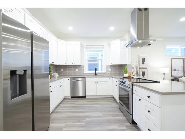 a large kitchen with cabinets and stainless steel appliances