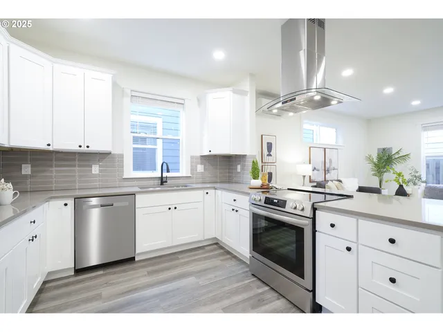a kitchen with a white cabinets and window