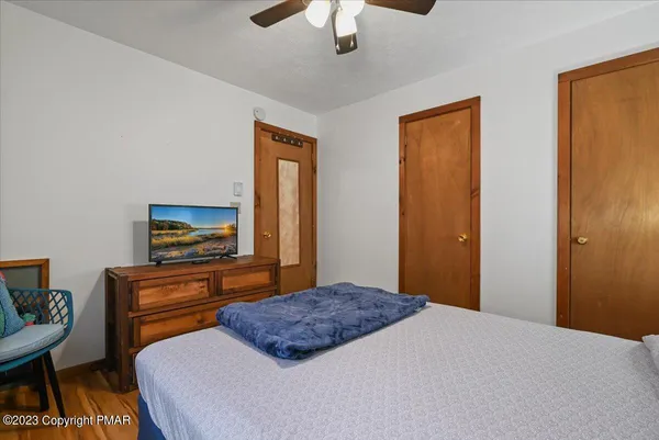 a bedroom with a bed and a painting on the wall