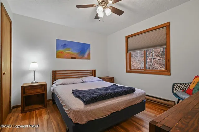 a bedroom with bed and wooden floor