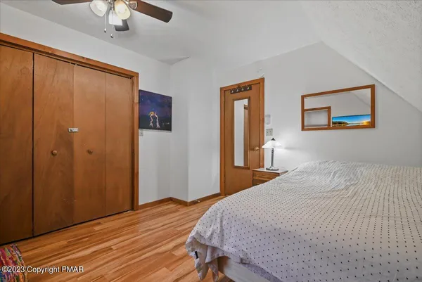 a view of a house with wooden deck and furniture