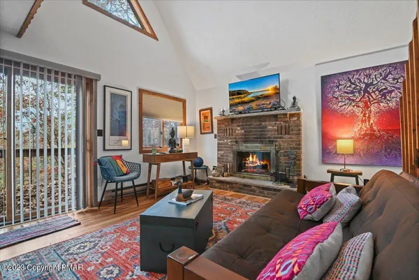 a room with stainless steel appliances a table and chairs