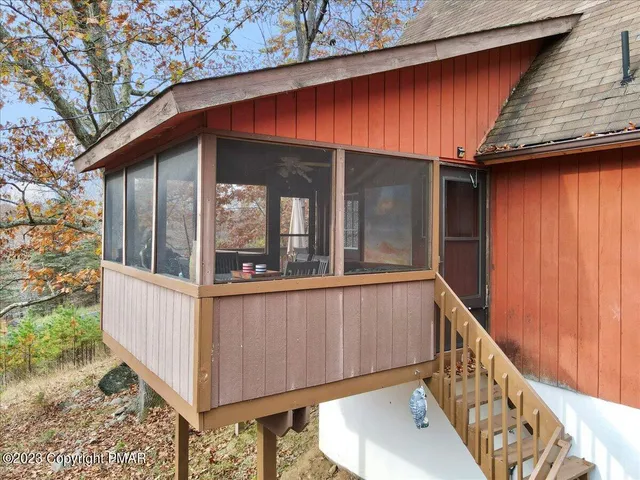 a room with stainless steel appliances a table and chairs