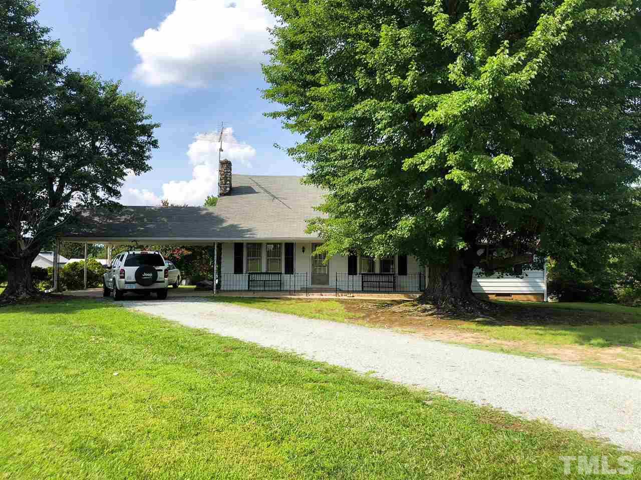 894 Shiloh Church Road Roxboro, NC 27574 - Photo 1 of 24 a view of a house with swimming pool and a yard