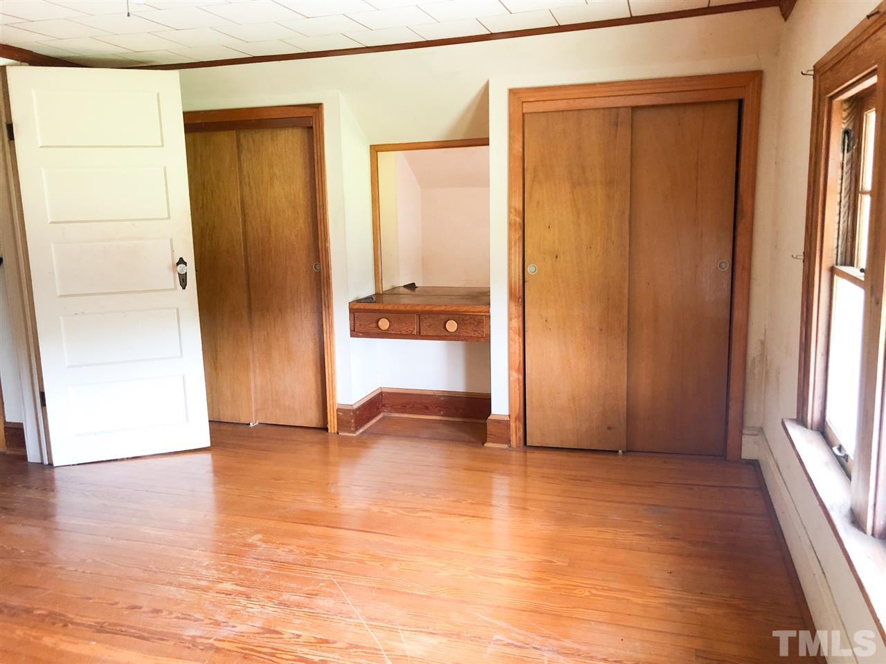 894 Shiloh Church Road Roxboro, NC 27574 - Photo 12 of 24 a view of an empty room with wooden floor and a window