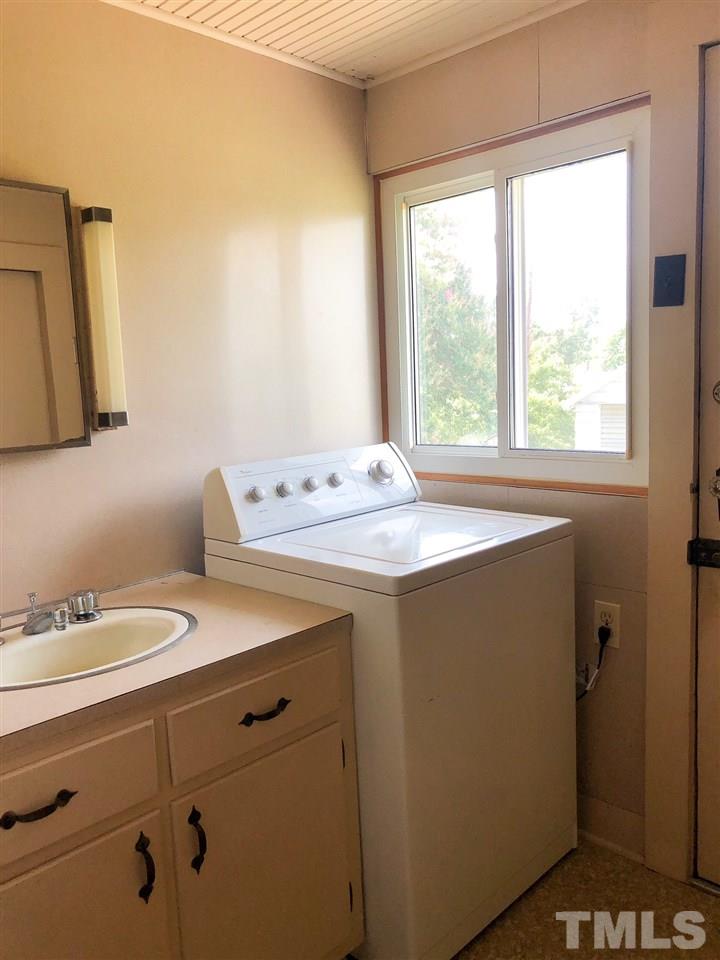894 Shiloh Church Road Roxboro, NC 27574 - Photo 14 of 24 a bathroom with a sink a vanity and a window