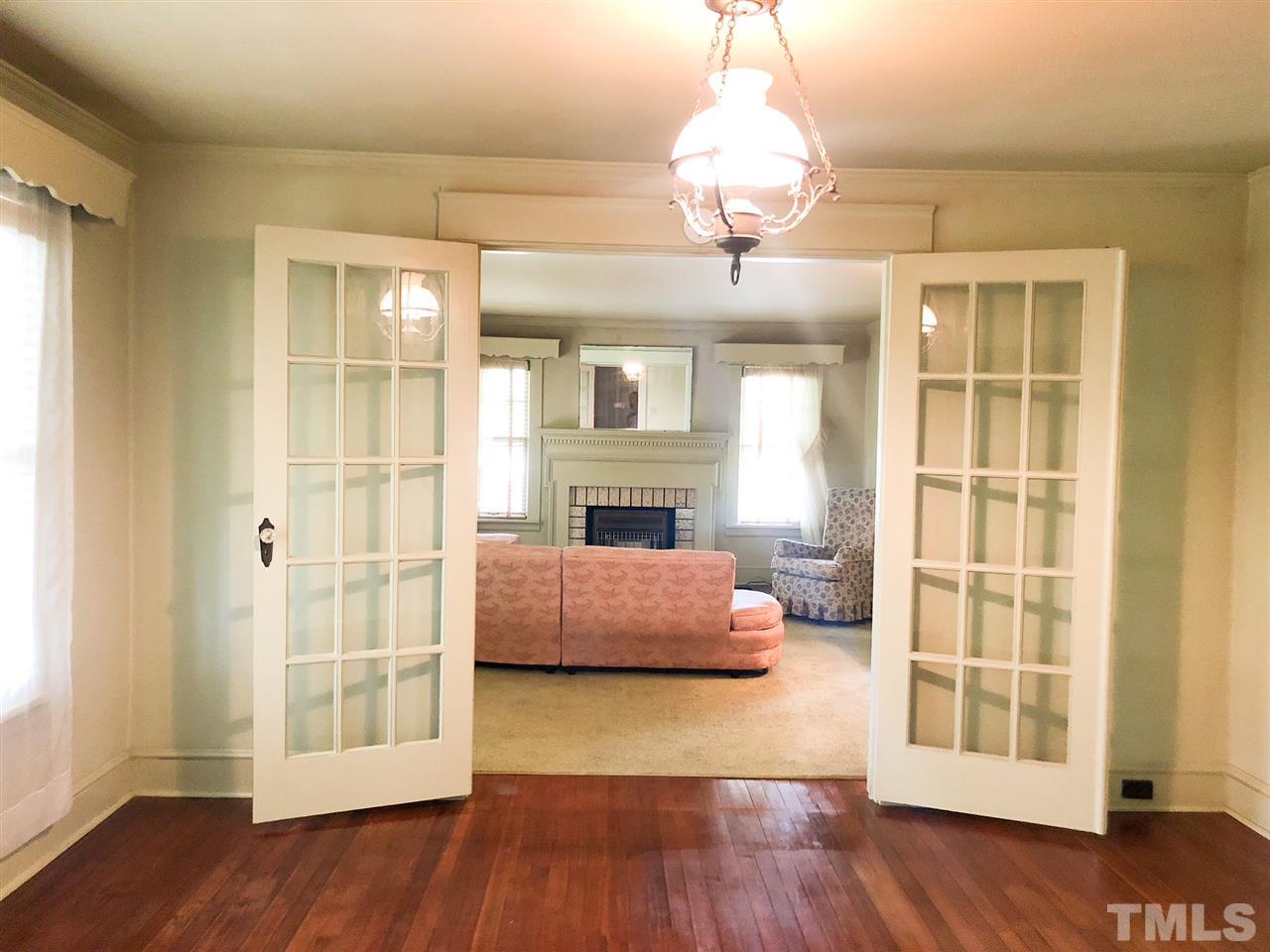 894 Shiloh Church Road Roxboro, NC 27574 - Photo 5 of 24 a view of a livingroom with a fireplace wooden floor and chandelier