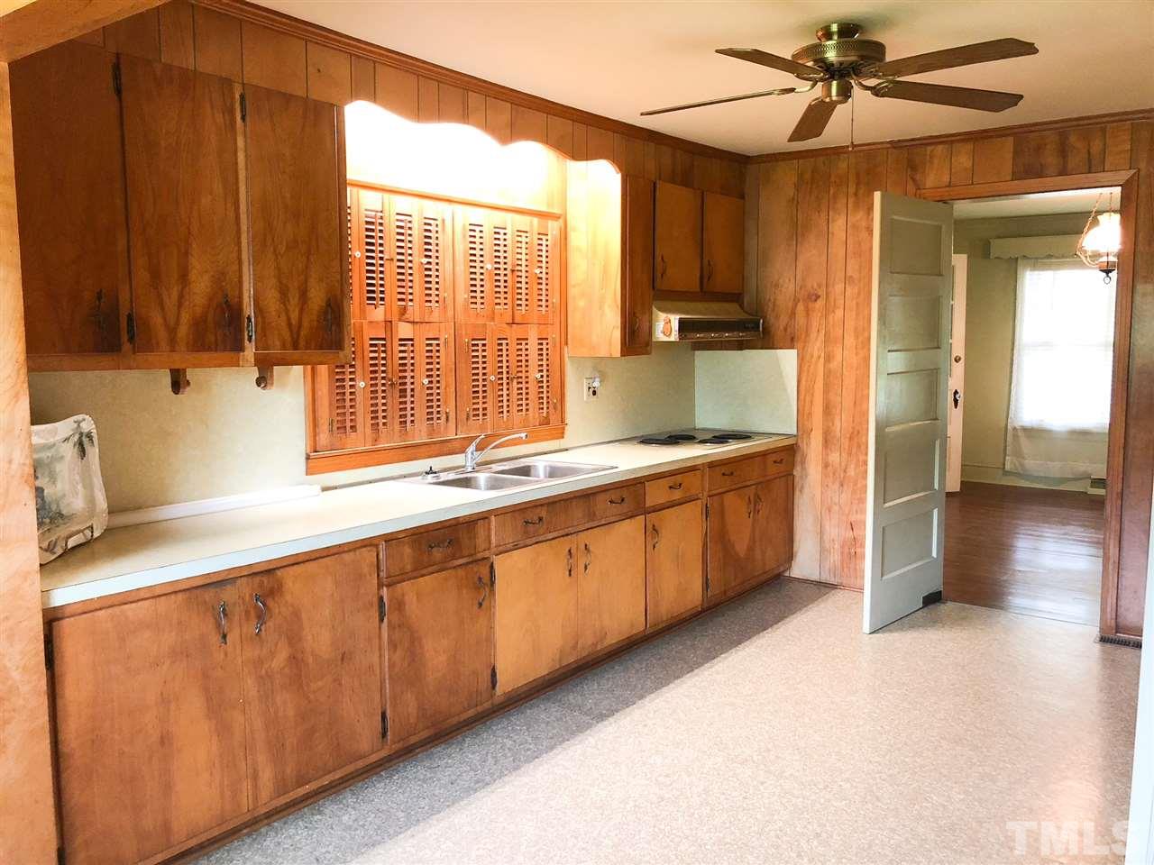 894 Shiloh Church Road Roxboro, NC 27574 - Photo 7 of 24 a large kitchen with kitchen island granite countertop a sink and a stove top oven