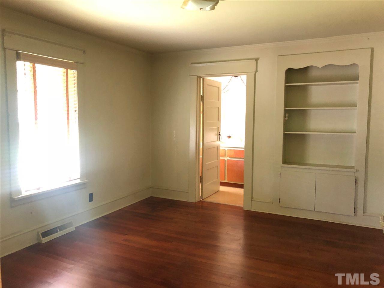 894 Shiloh Church Road Roxboro, NC 27574 - Photo 10 of 24 an empty room with wooden floor closet and windows
