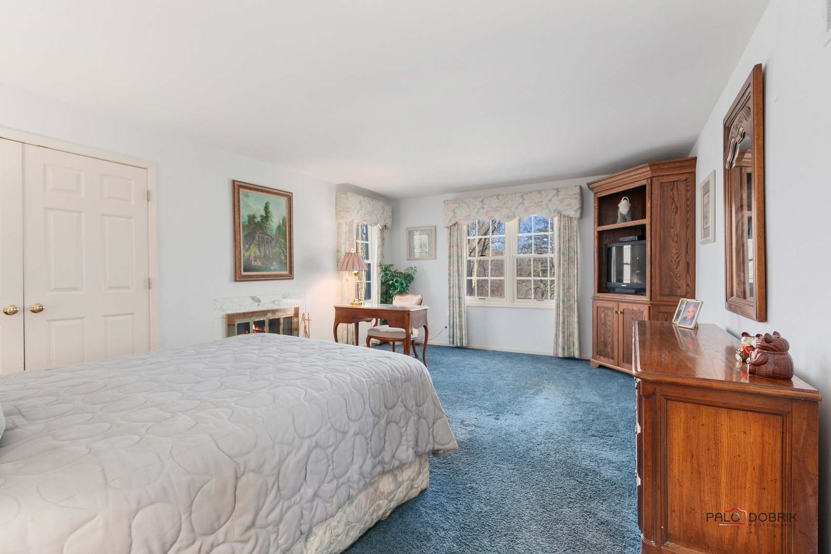 950 Old Mill Road Lake Forest, IL 60045 - Photo 25 of 59 a spacious bedroom with a bed a dresser and a window