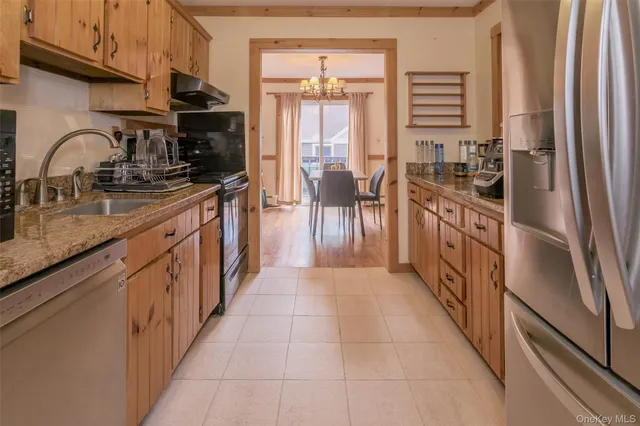 a kitchen with granite countertop a sink stove and cabinets