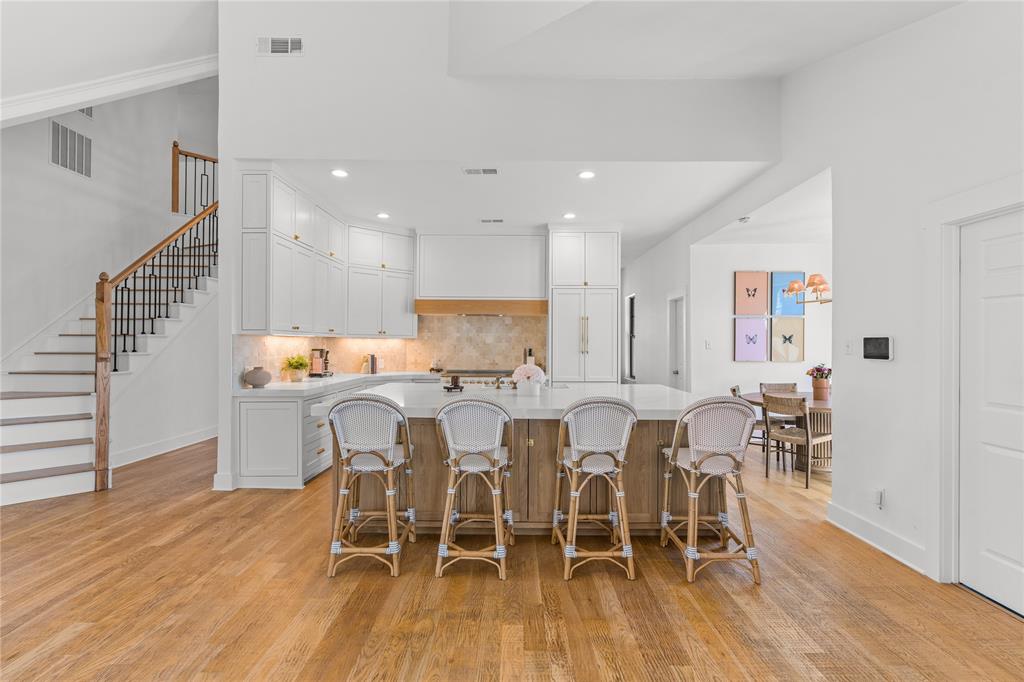 990 Cornelius Road Rockwall, TX 75087 - Photo 12 of 37 a dining room with furniture wooden floor a rug and a painting