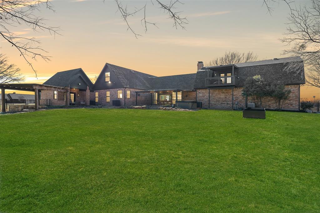 990 Cornelius Road Rockwall, TX 75087 - Photo 36 of 37 a view of a brick house next to a big yard and large trees