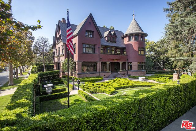 a front view of a house with swimming pool having outdoor seating