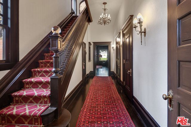 a view of a hallway with wooden floor and stairs