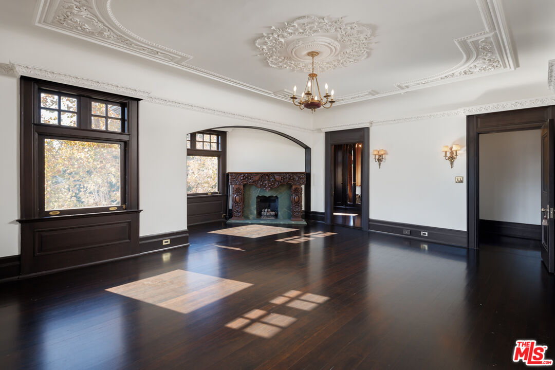 357 Lorraine Boulevard Los Angeles, CA 90020 - Photo 18 of 34 a view of a livingroom with wooden floor and a fireplace