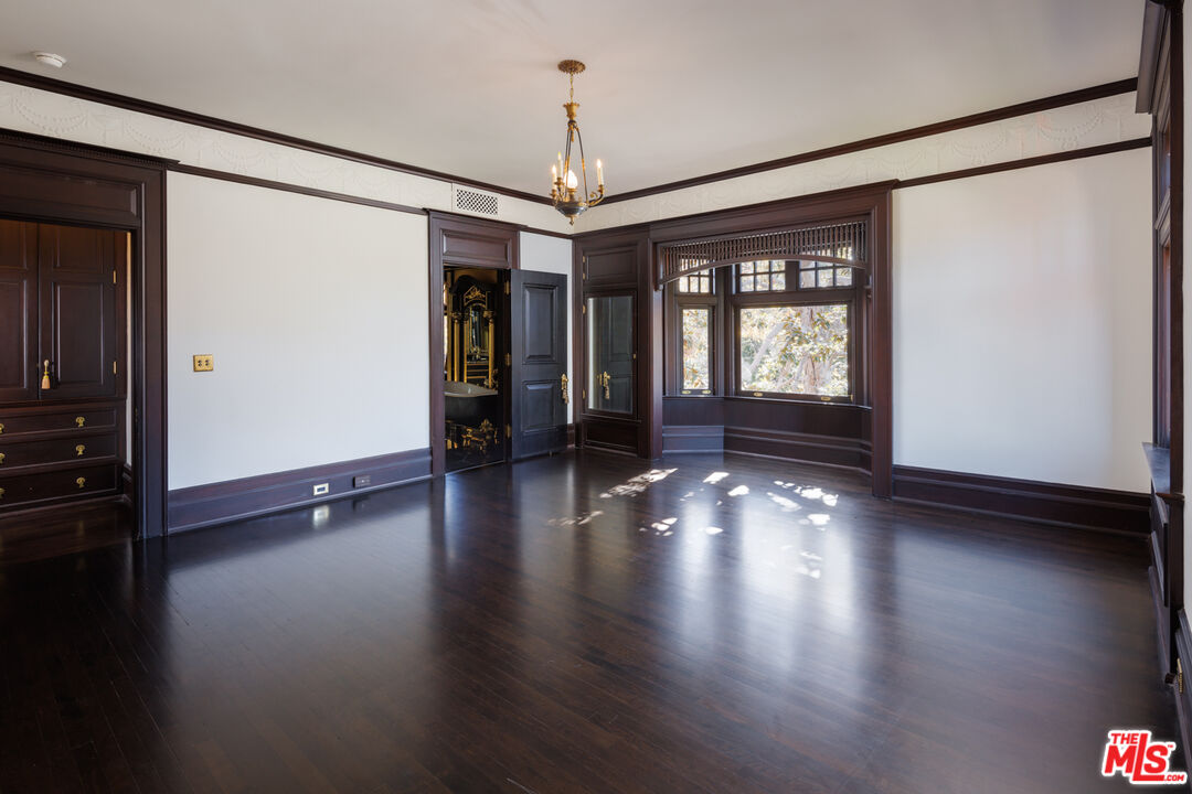 357 Lorraine Boulevard Los Angeles, CA 90020 - Photo 19 of 34 an empty room with wooden floor and windows