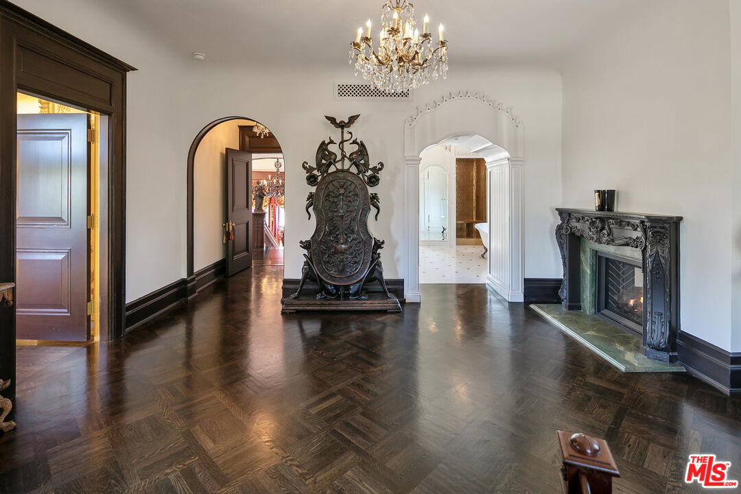 357 Lorraine Boulevard Los Angeles, CA 90020 - Photo 21 of 34 a view of a livingroom with fireplace wooden floor and a chandelier