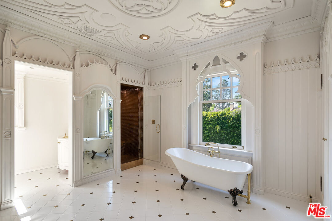 357 Lorraine Boulevard Los Angeles, CA 90020 - Photo 22 of 34 a bathroom with a sink a toilet and a large mirror