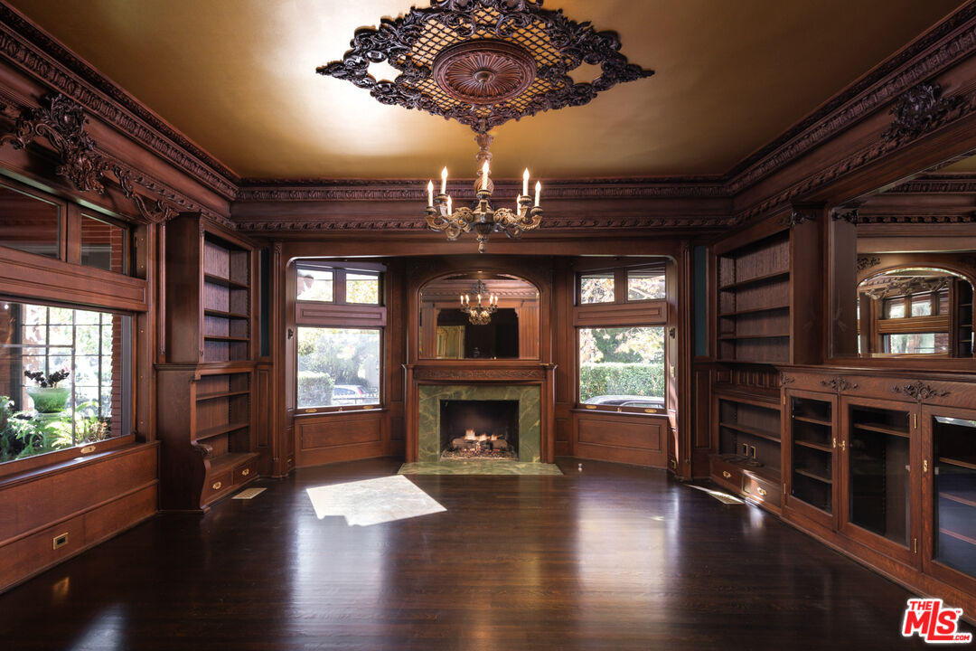 357 Lorraine Boulevard Los Angeles, CA 90020 - Photo 7 of 34 a view of an empty room with wooden floor fireplace and a window