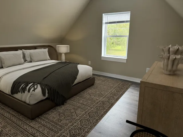 a bedroom with a bed and window