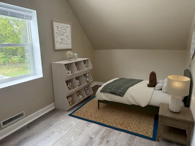 a bedroom with furniture and a window