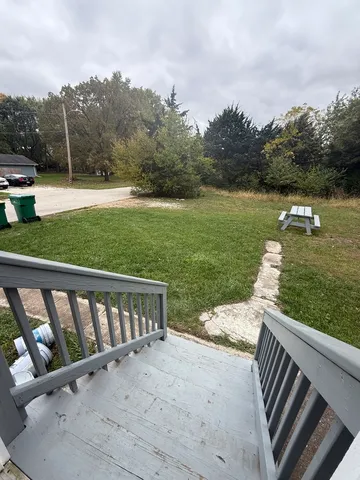 a view of a deck with a yard and ocean view