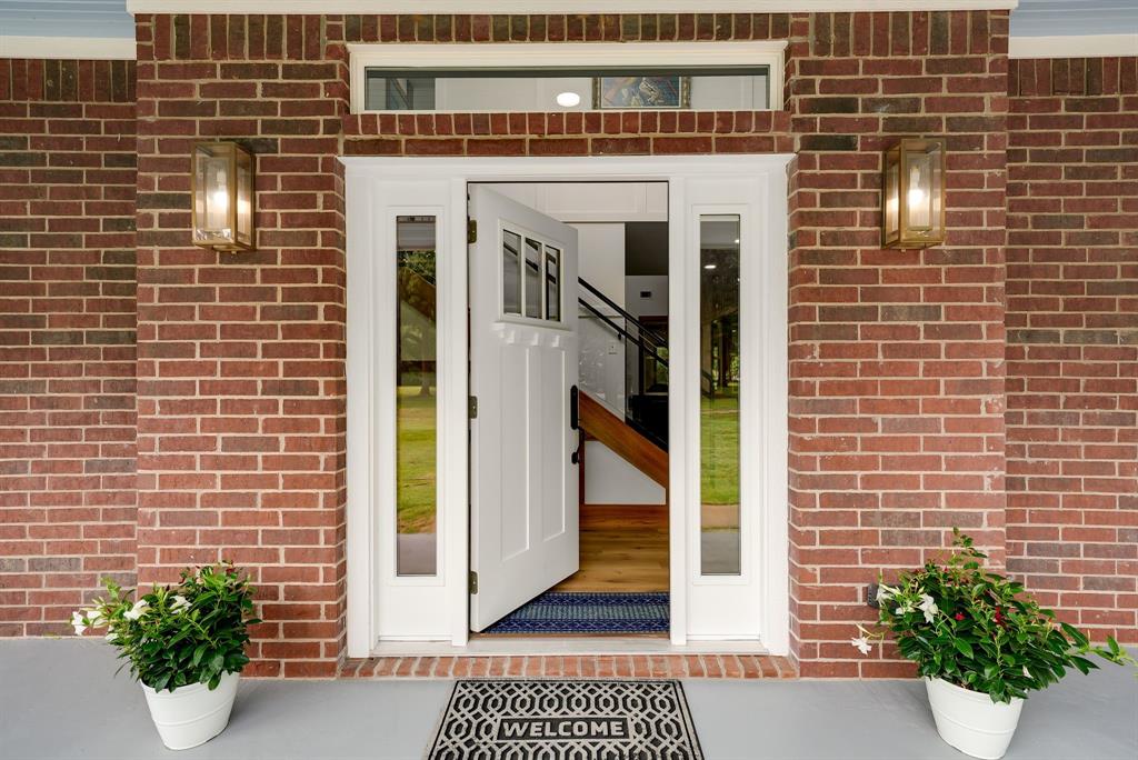 1037 Harrison Road Denison, TX 75021 - Photo 7 of 39 Brick facade with white trim surrounding the entryway