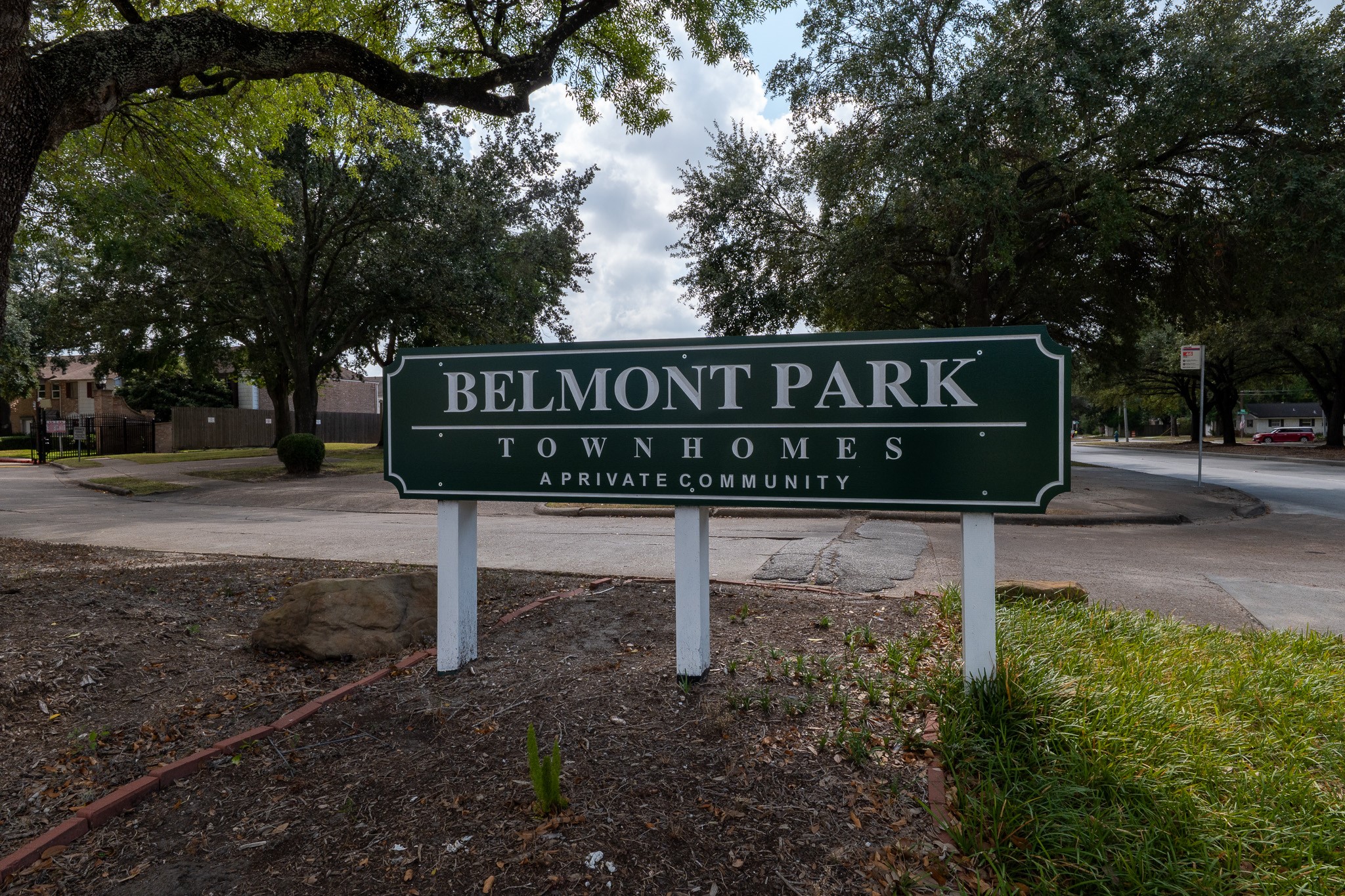 a sign that is sitting on a wooden bench