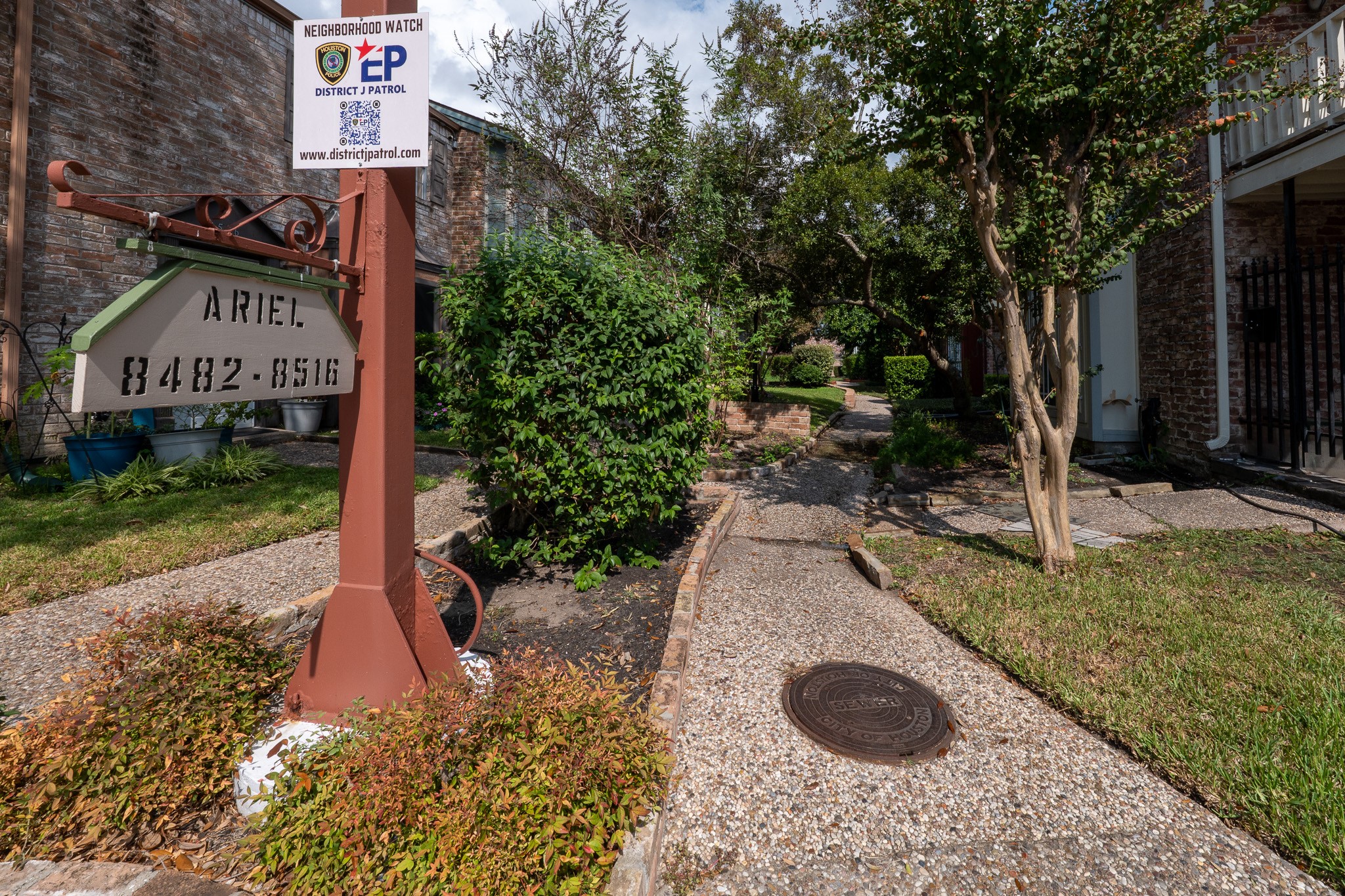 8486 Ariel Street Houston, TX 77074 - Photo 11 of 45 a sign board with a yard and plants
