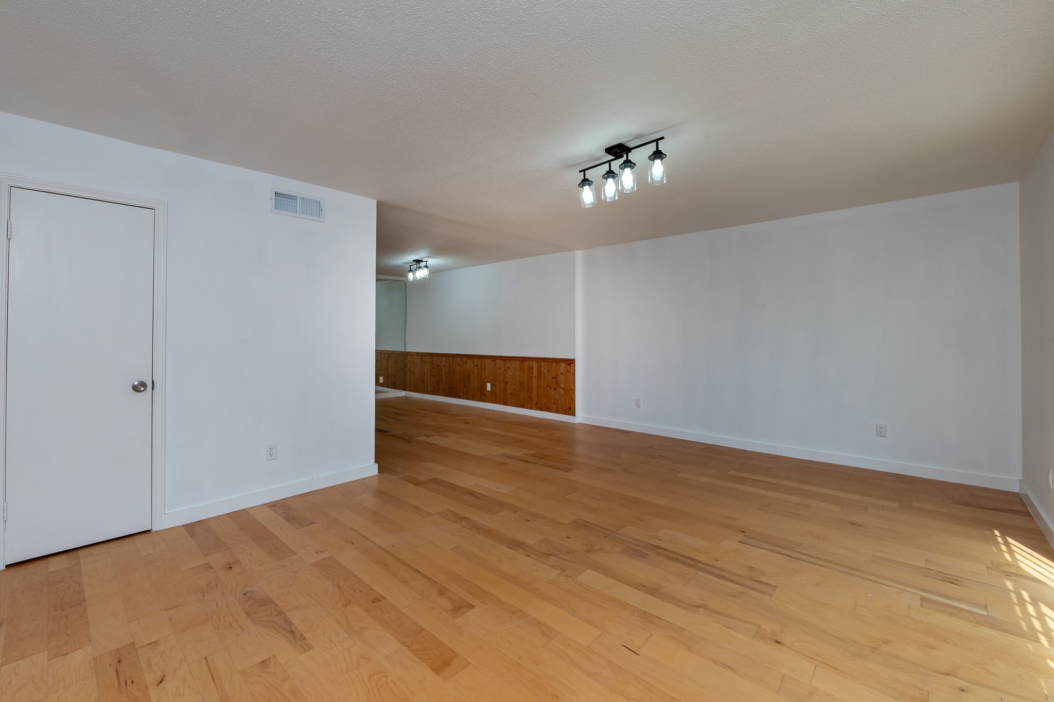 8486 Ariel Street Houston, TX 77074 - Photo 28 of 45 a view of empty room with wooden floor and ceiling fan