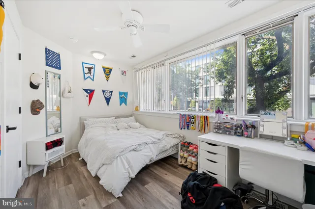 a bedroom with a bed and a large window