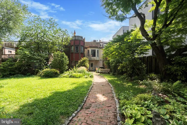 a view of backyard of house with green space