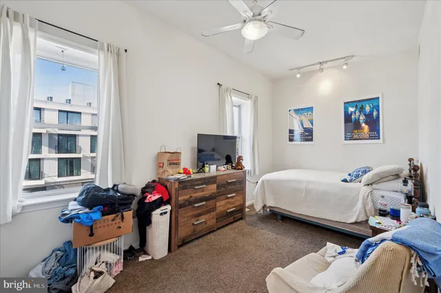 a bedroom with bed and a chandelier