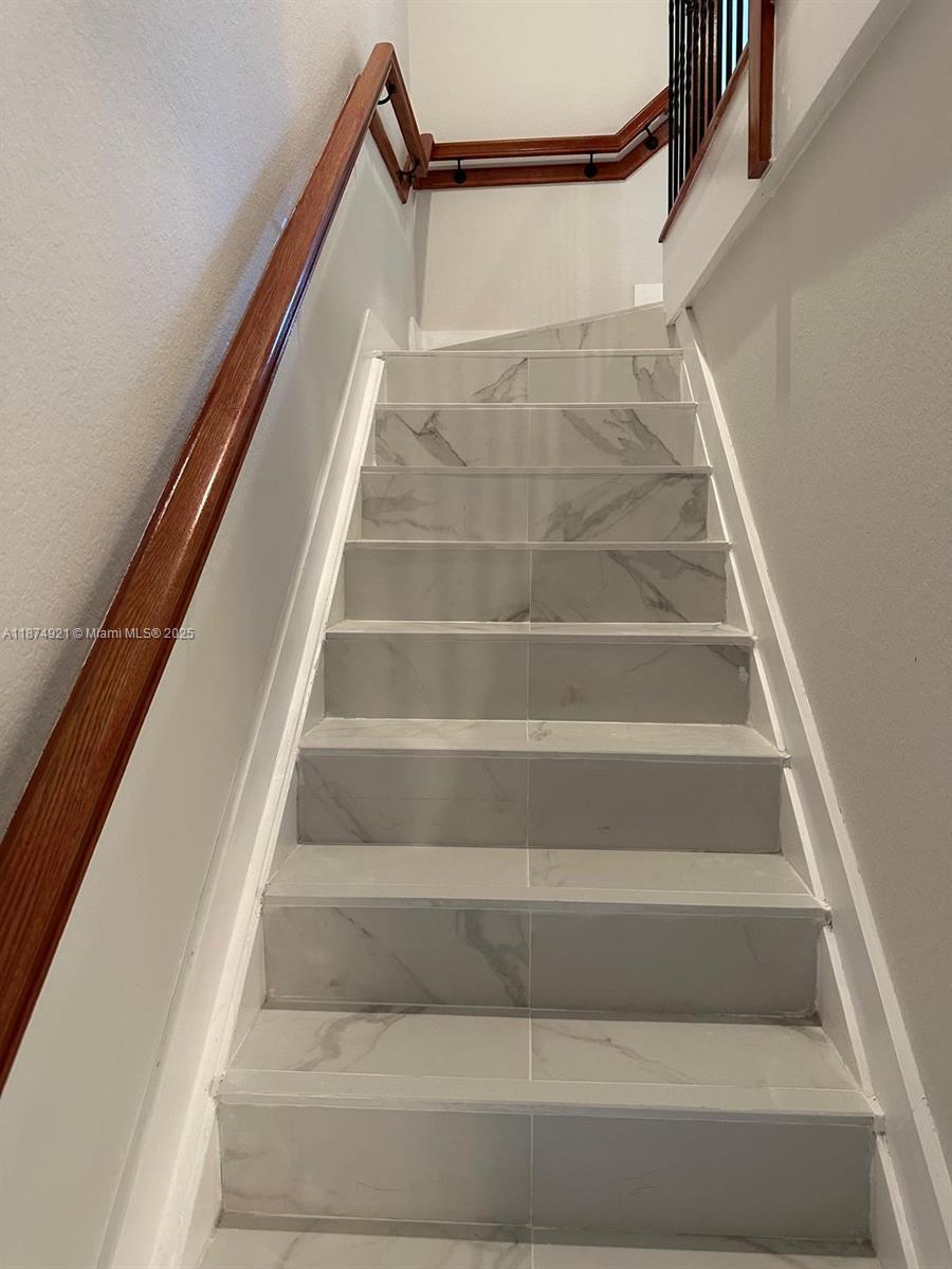 12421 Southwest 50th Court, Unit 337 Miramar, FL 33027 - Photo 11 of 46 a view of staircase with white walls and a window