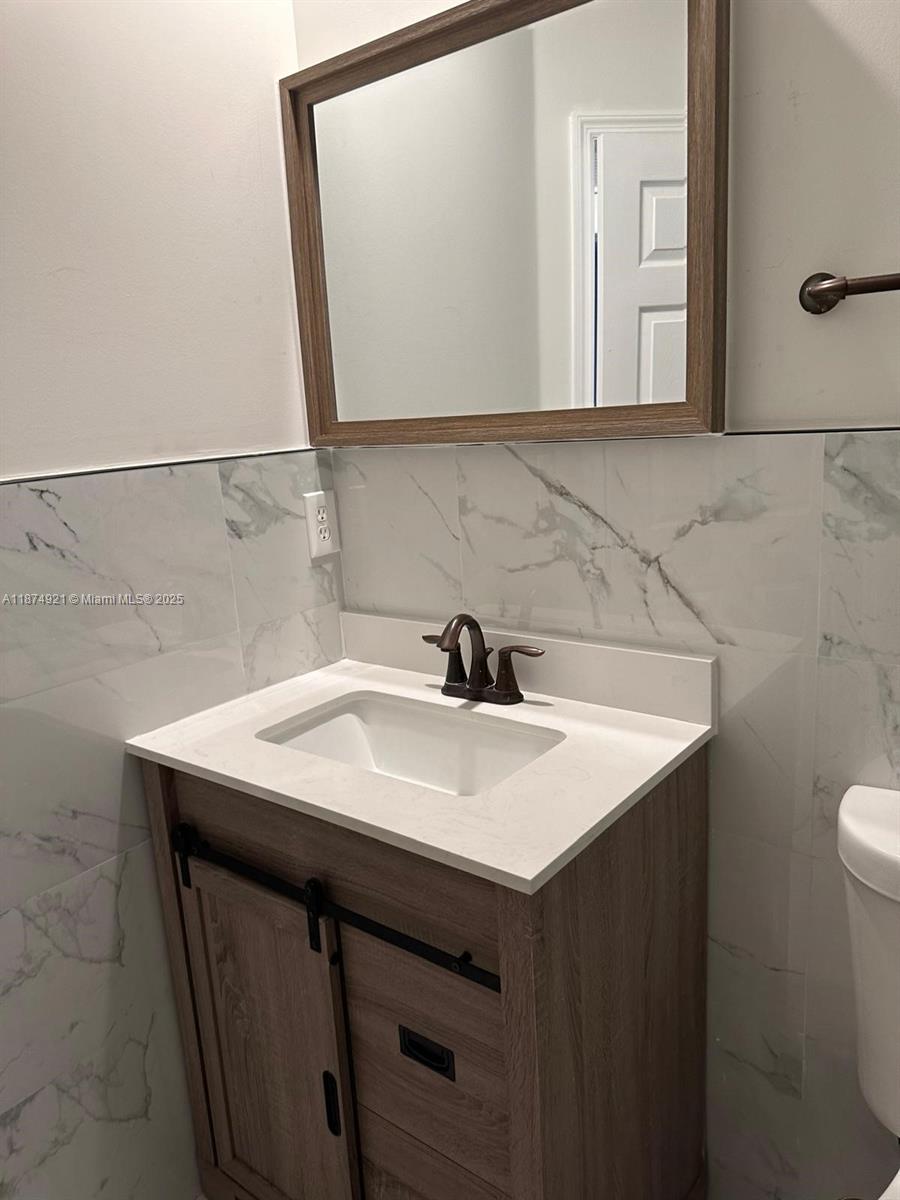 12421 Southwest 50th Court, Unit 337 Miramar, FL 33027 - Photo 41 of 46 a bathroom with a sink and a mirror