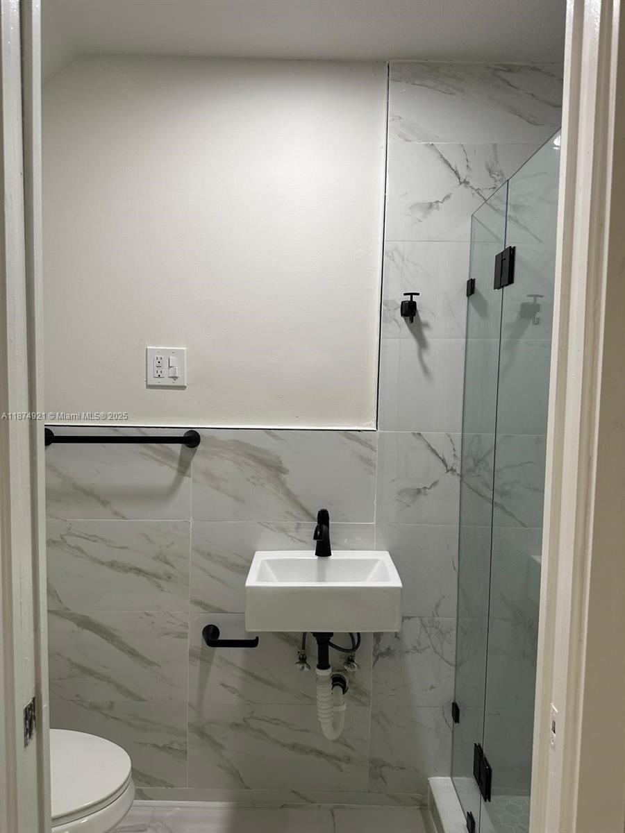 12421 Southwest 50th Court, Unit 337 Miramar, FL 33027 - Photo 44 of 46 a bathroom with a sink toilet and shower