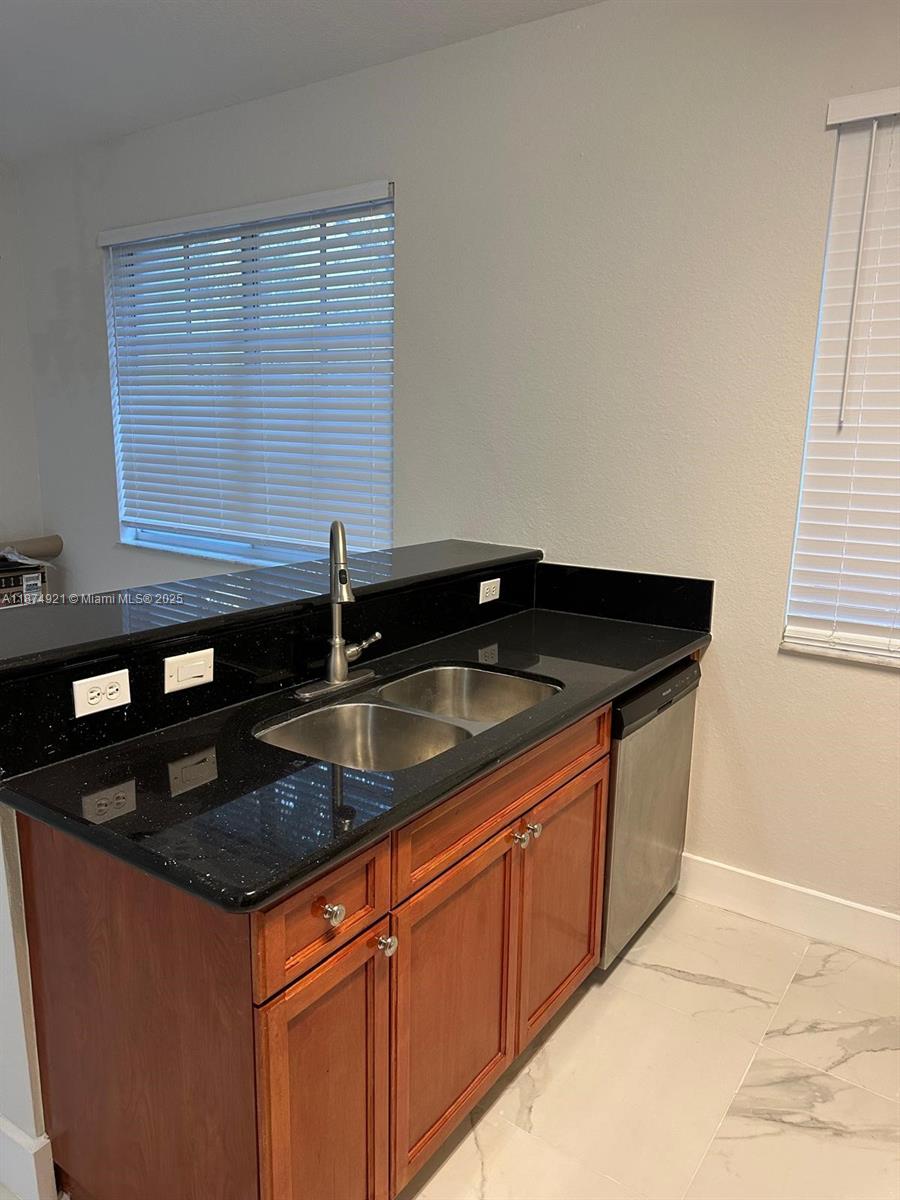 12421 Southwest 50th Court, Unit 337 Miramar, FL 33027 - Photo 9 of 46 a kitchen that has a sink and cabinets