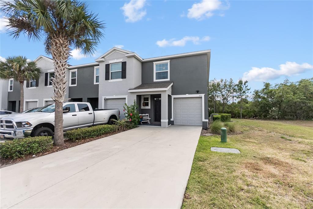 8990 Indigo Trail Loop Riverview, FL 33578 - Photo 2 of 43 a front view of a house with garden