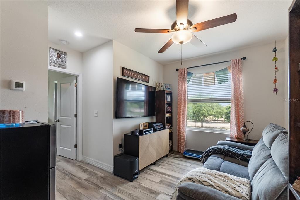 8990 Indigo Trail Loop Riverview, FL 33578 - Photo 21 of 43 a living room with furniture and a flat screen tv