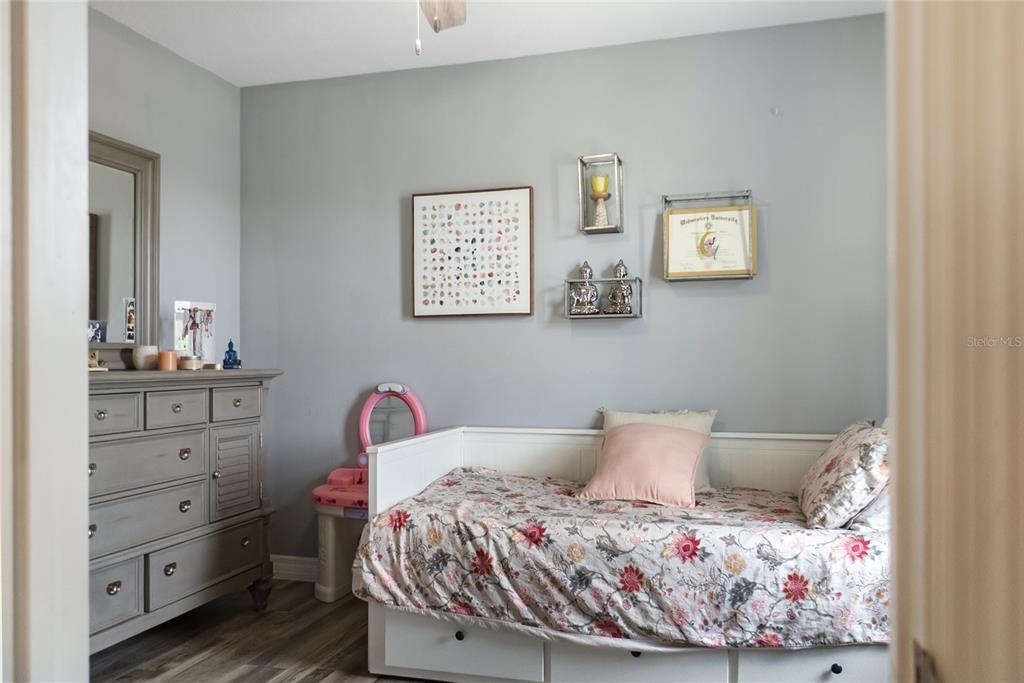 8990 Indigo Trail Loop Riverview, FL 33578 - Photo 29 of 43 a bedroom with a bed and cabinet